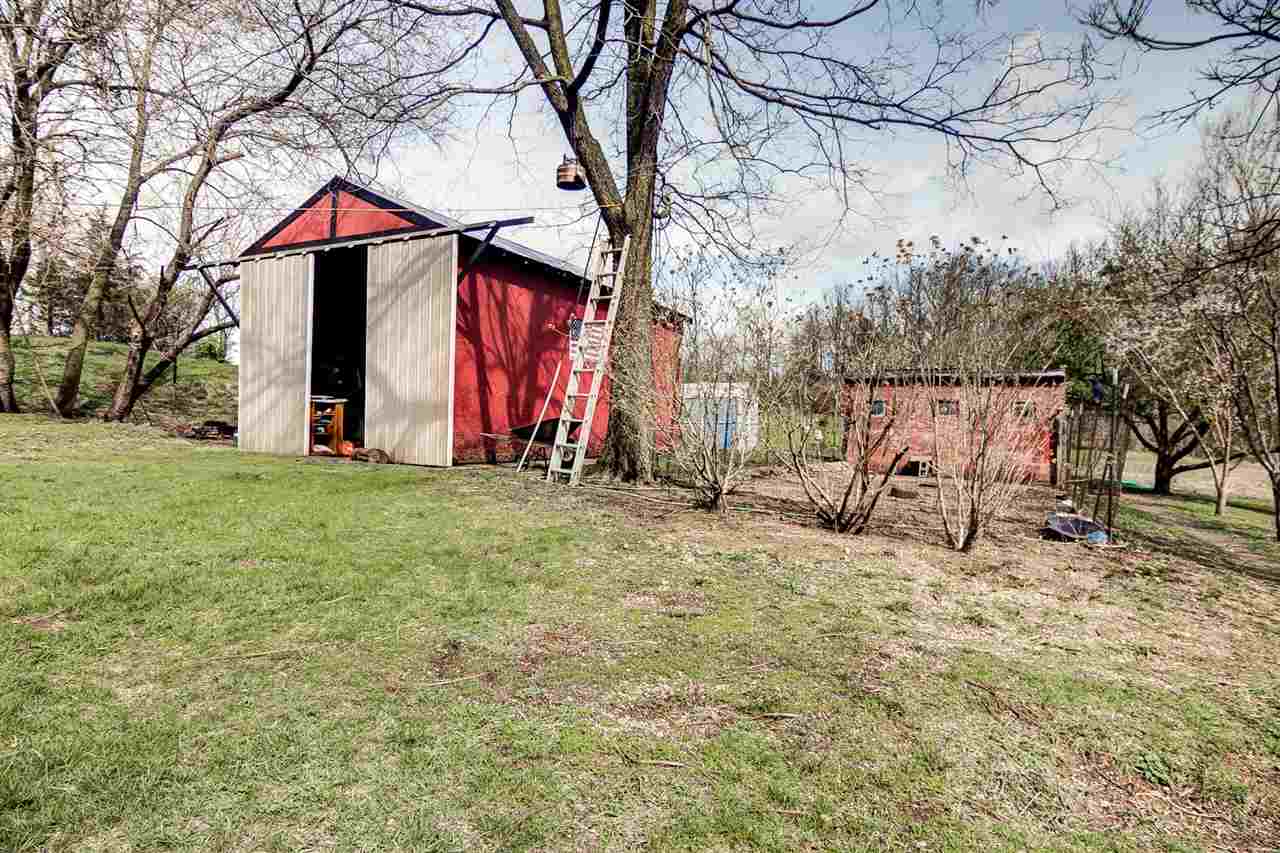 6155 Perryville Road Cherry Valley, IL 61016 - Photo 6 of 25 a view of house with backyard and trees