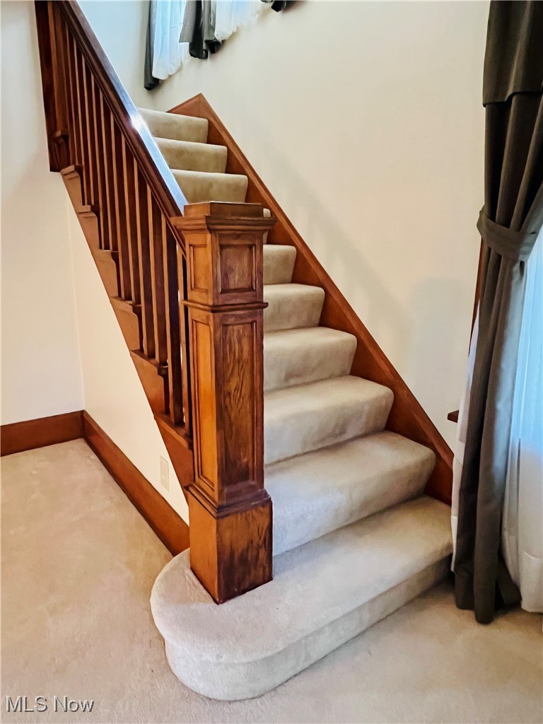 4704 South Ridge Road East Geneva, OH 44041 - Photo 26 of 49 Stairway featuring baseboards and carpet floors