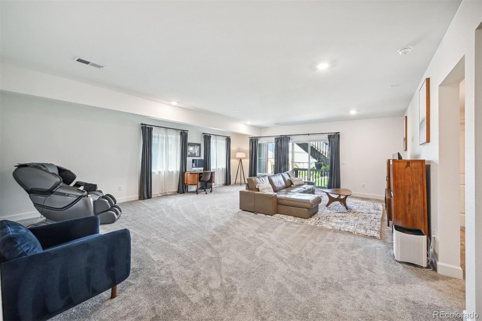 347 Felicity Loop Castle Rock, CO 80109 - Photo 21 of 28 a living room with furniture and a flat screen tv