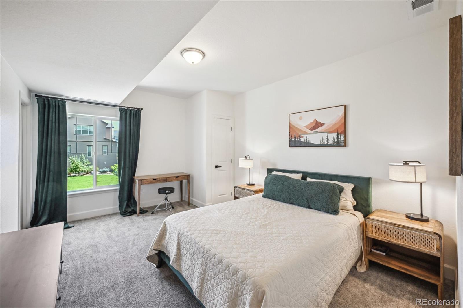 347 Felicity Loop Castle Rock, CO 80109 - Photo 23 of 28 a bedroom with a bed and a painting on the wall