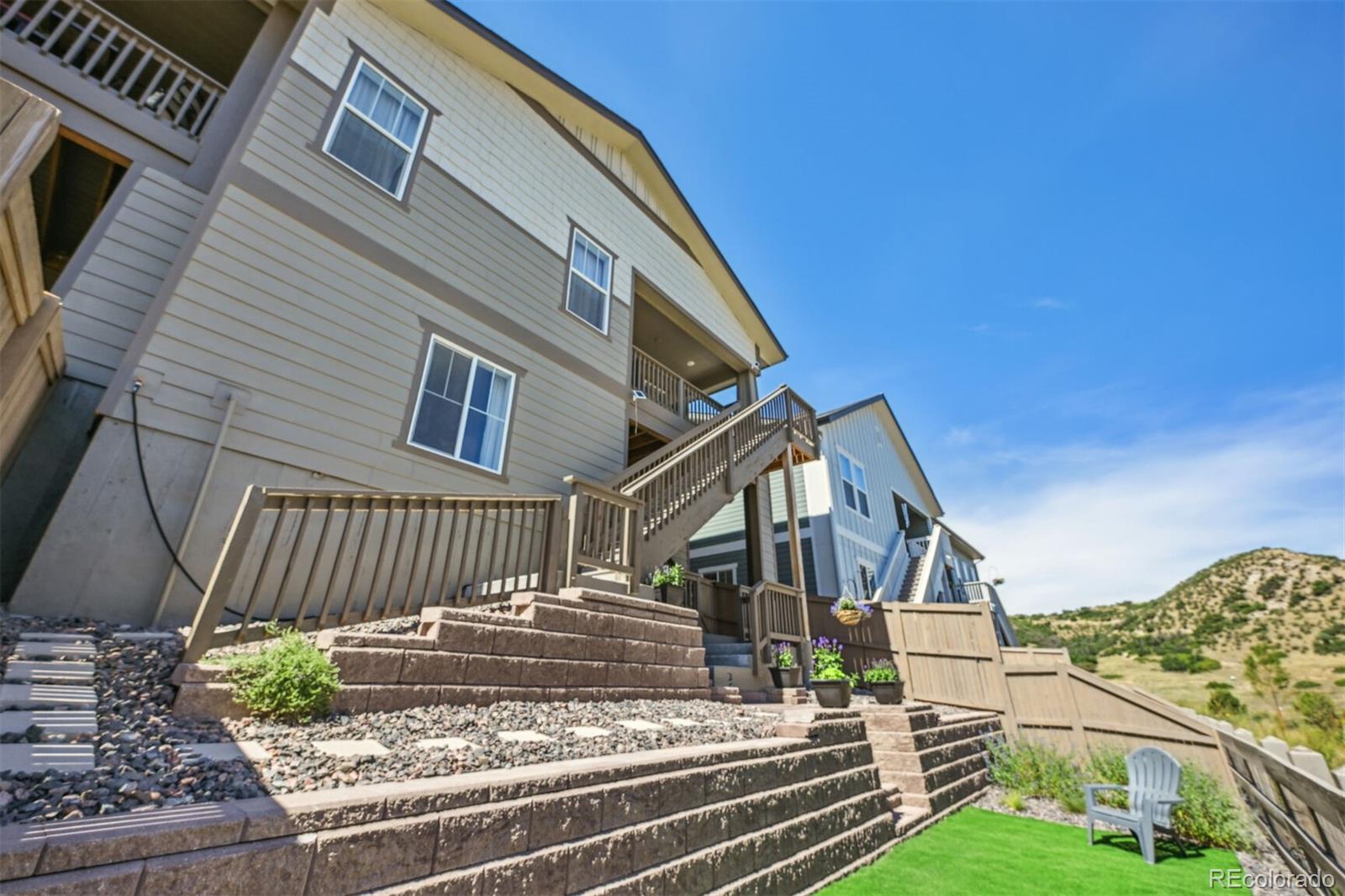 347 Felicity Loop Castle Rock, CO 80109 - Photo 26 of 28 a view of a house with a small yard and wooden fence