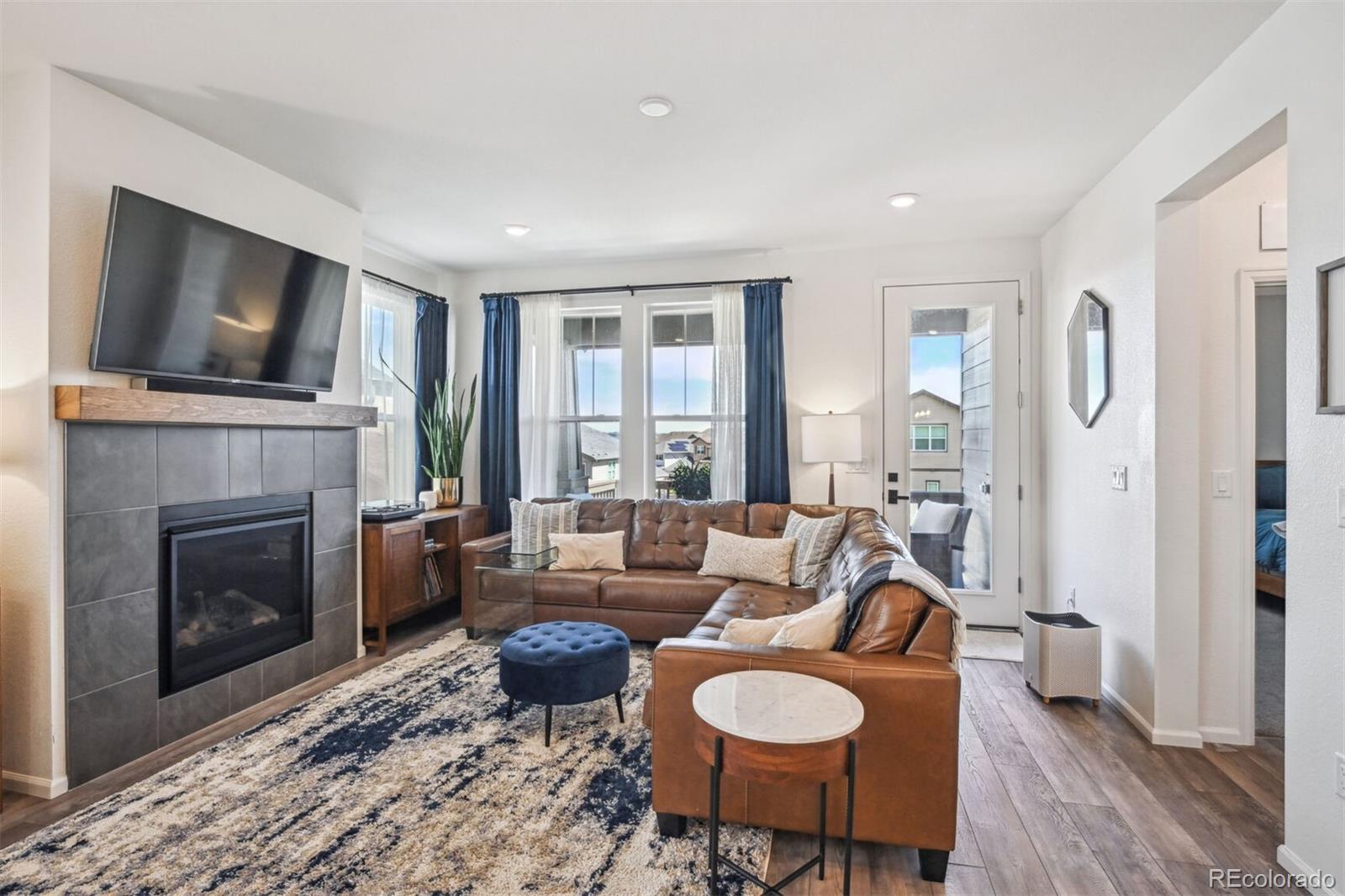 347 Felicity Loop Castle Rock, CO 80109 - Photo 3 of 28 a living room with furniture fireplace and flat screen tv