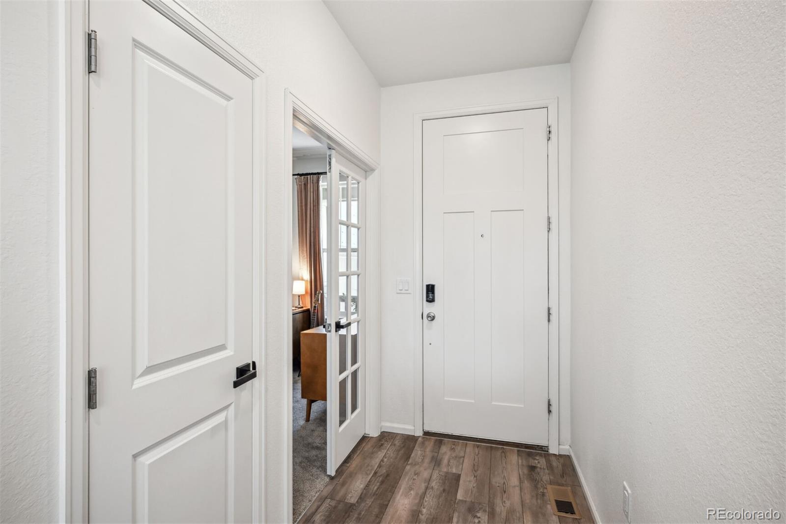 347 Felicity Loop Castle Rock, CO 80109 - Photo 7 of 28 a view of a hallway with wooden floor and entryway