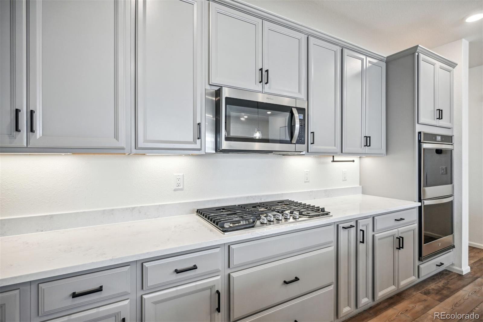 347 Felicity Loop Castle Rock, CO 80109 - Photo 10 of 28 a kitchen with cabinets appliances and a counter space