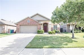 1409 Rosson Road Little Elm, TX 75068 - Photo 1 of 34 Brick facade home featuring a two-car garage, mature front yard tree, established shrubbery, and a concrete driveway with an integrated walkway