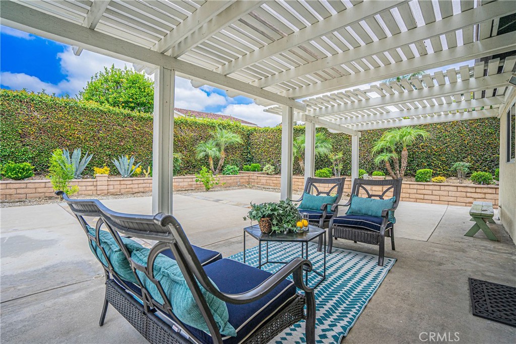 1301 Eltham Place Fullerton, CA 92833 - Photo 26 of 26 a view of a patio with table and chairs potted plants with wooden floor and fence