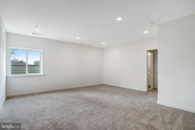 a view of staircase with white walls and stairs