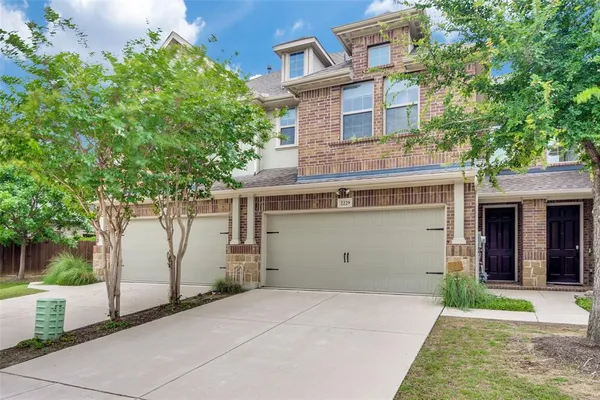 a view of a house with a yard and garage