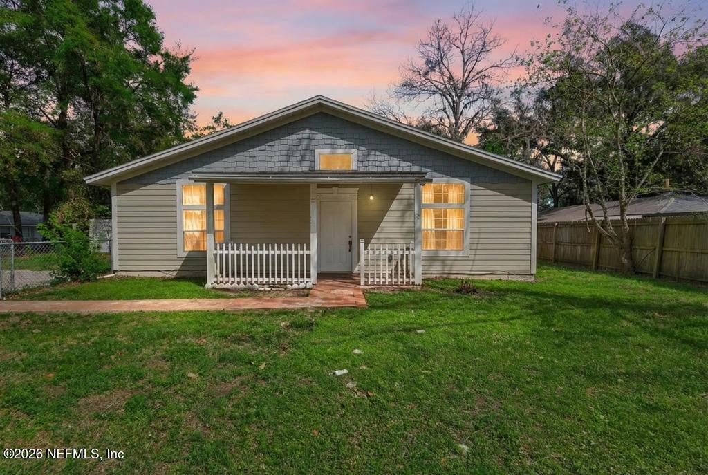 a front view of house with yard and green space