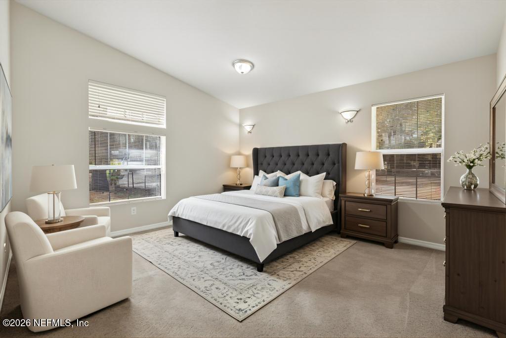10803 Gladwynne Road Jacksonville, FL 32218 - Photo 11 of 44 a bedroom with a large bed and a couch