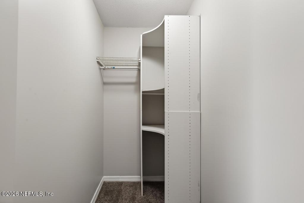 10803 Gladwynne Road Jacksonville, FL 32218 - Photo 14 of 44 a view of walk in closet with empty racks