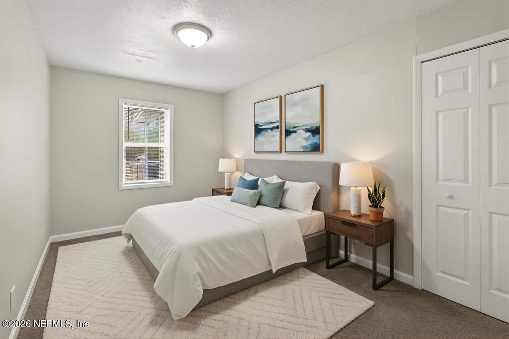 10803 Gladwynne Road Jacksonville, FL 32218 - Photo 24 of 44 a bedroom with a bed and a window