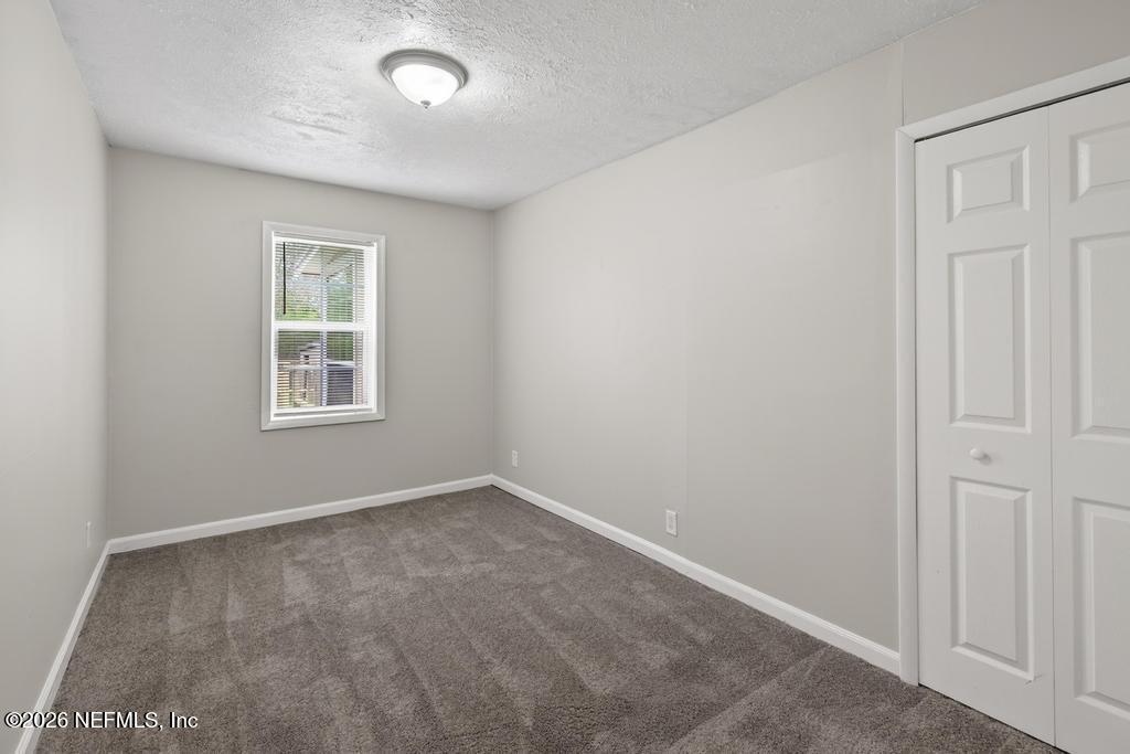 10803 Gladwynne Road Jacksonville, FL 32218 - Photo 25 of 44 an empty room with windows