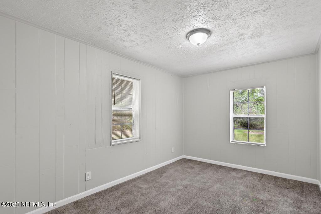 10803 Gladwynne Road Jacksonville, FL 32218 - Photo 27 of 44 an empty room with windows and closet