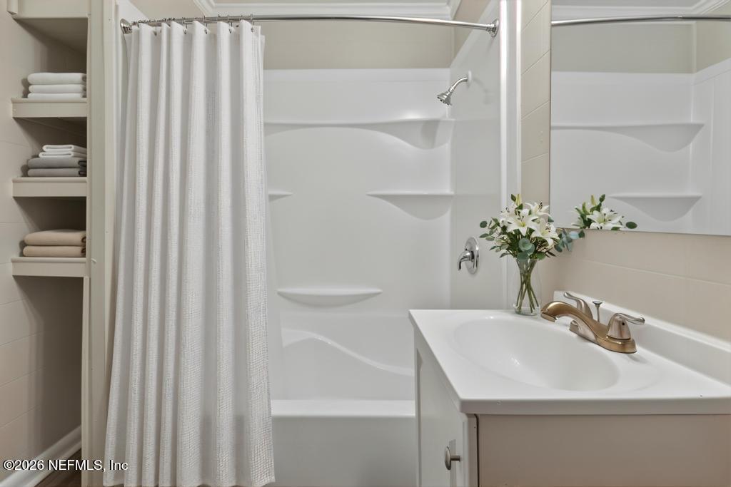 10803 Gladwynne Road Jacksonville, FL 32218 - Photo 28 of 44 a bathroom with a sink and a mirror