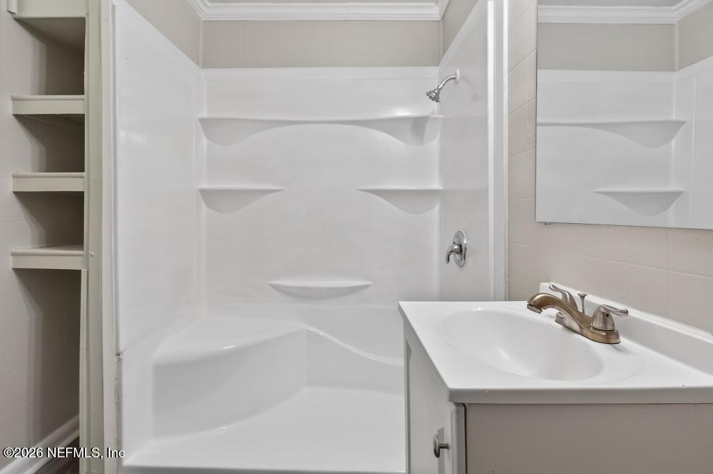 10803 Gladwynne Road Jacksonville, FL 32218 - Photo 29 of 44 a bathroom with a sink and a mirror