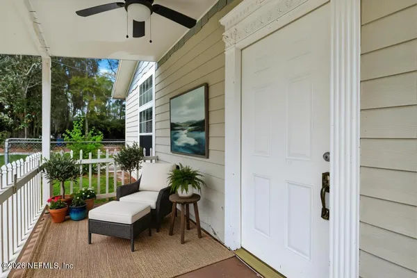 a balcony with furniture and a potted plant