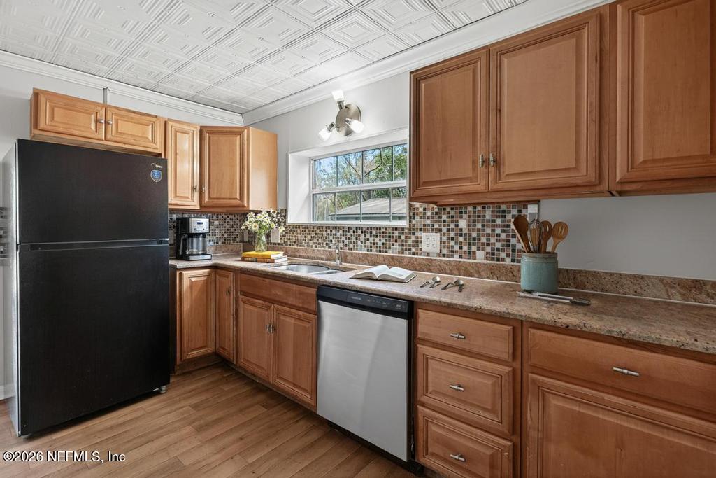 10803 Gladwynne Road Jacksonville, FL 32218 - Photo 32 of 44 a kitchen with stainless steel appliances granite countertop a refrigerator and a sink