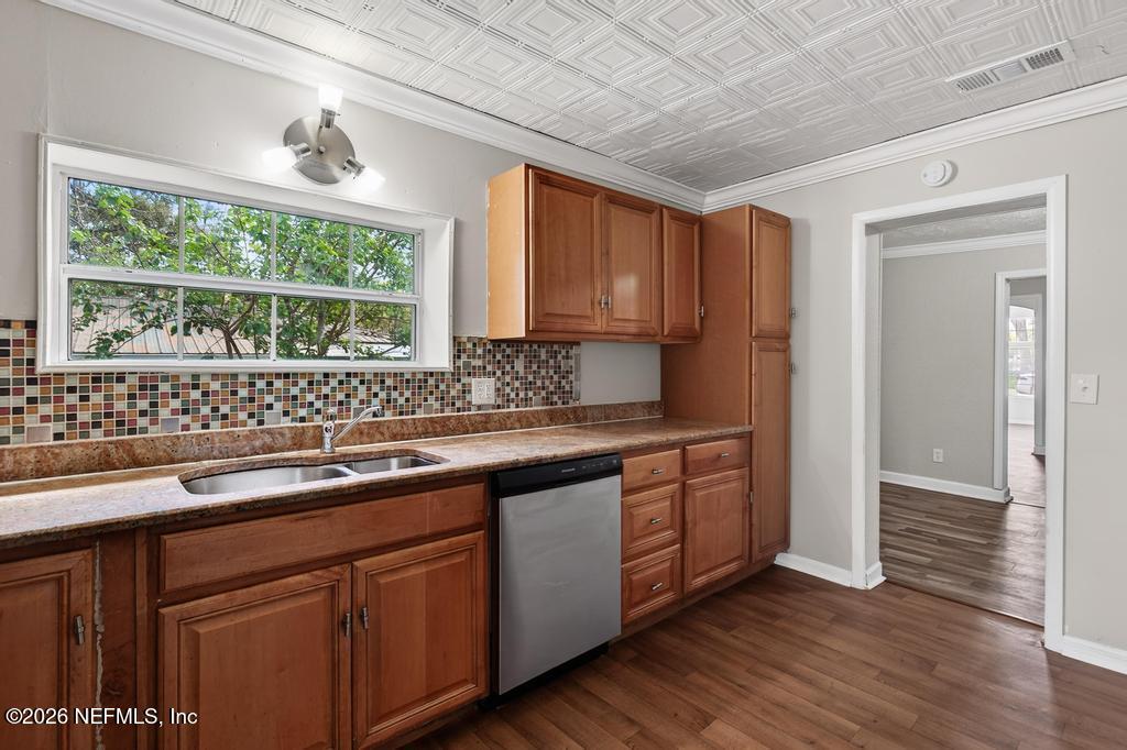 10803 Gladwynne Road Jacksonville, FL 32218 - Photo 35 of 44 a kitchen with stainless steel appliances granite countertop wooden floors a sink and a window