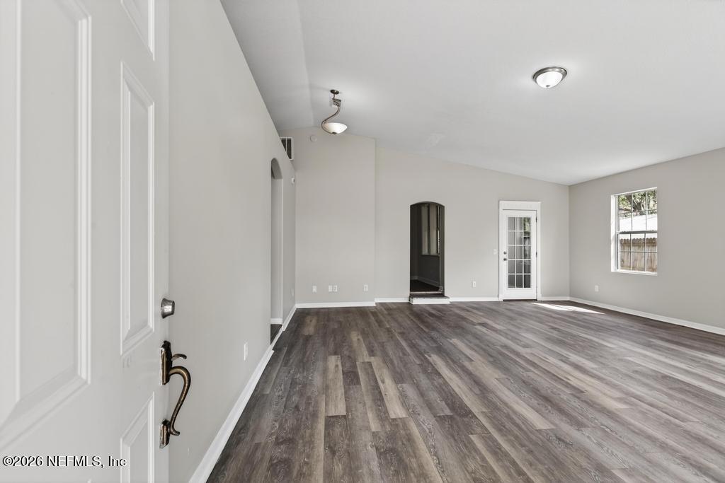 10803 Gladwynne Road Jacksonville, FL 32218 - Photo 4 of 44 a view of an empty room with wooden floor and a window