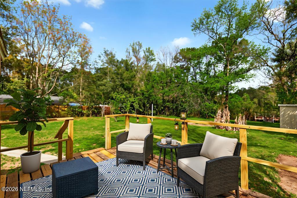 10803 Gladwynne Road Jacksonville, FL 32218 - Photo 41 of 44 a view of a patio with couches chairs and a yard