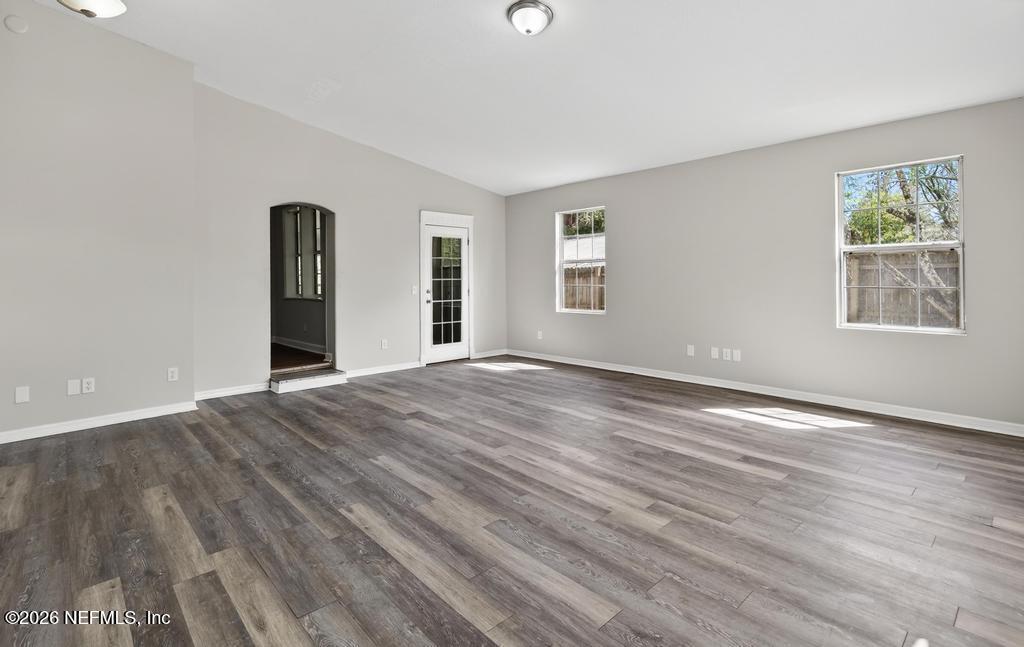 10803 Gladwynne Road Jacksonville, FL 32218 - Photo 5 of 44 a view of an empty room with wooden floor and a window