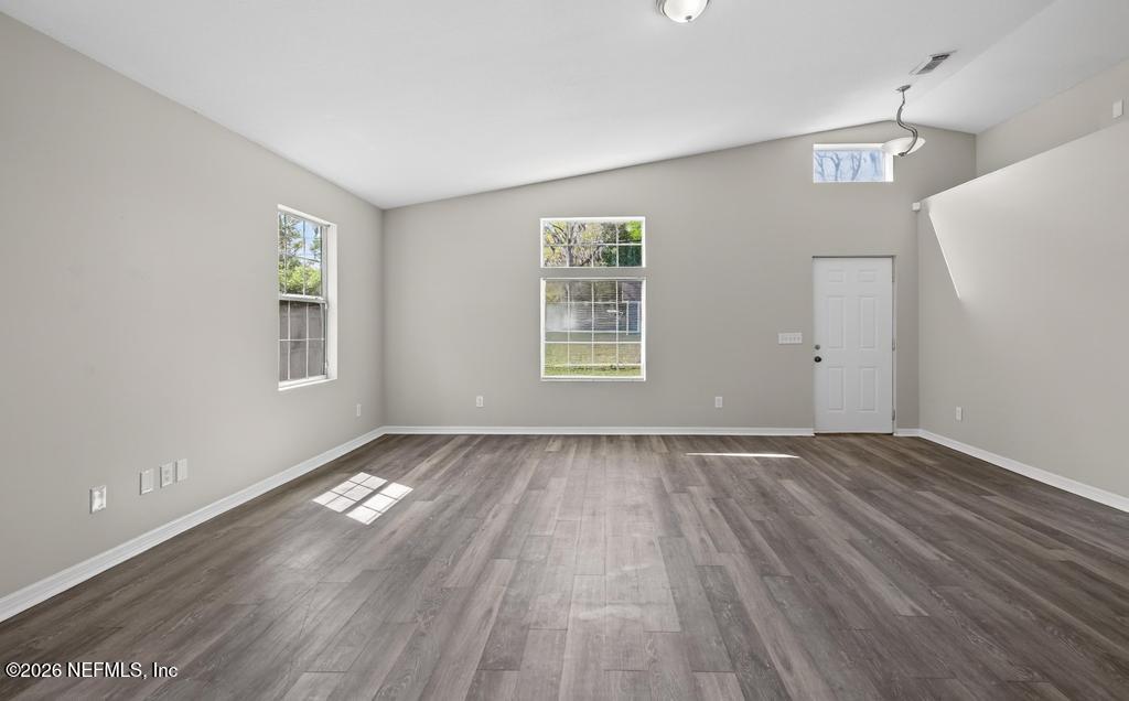 10803 Gladwynne Road Jacksonville, FL 32218 - Photo 7 of 44 a view of an empty room with wooden floor and a window