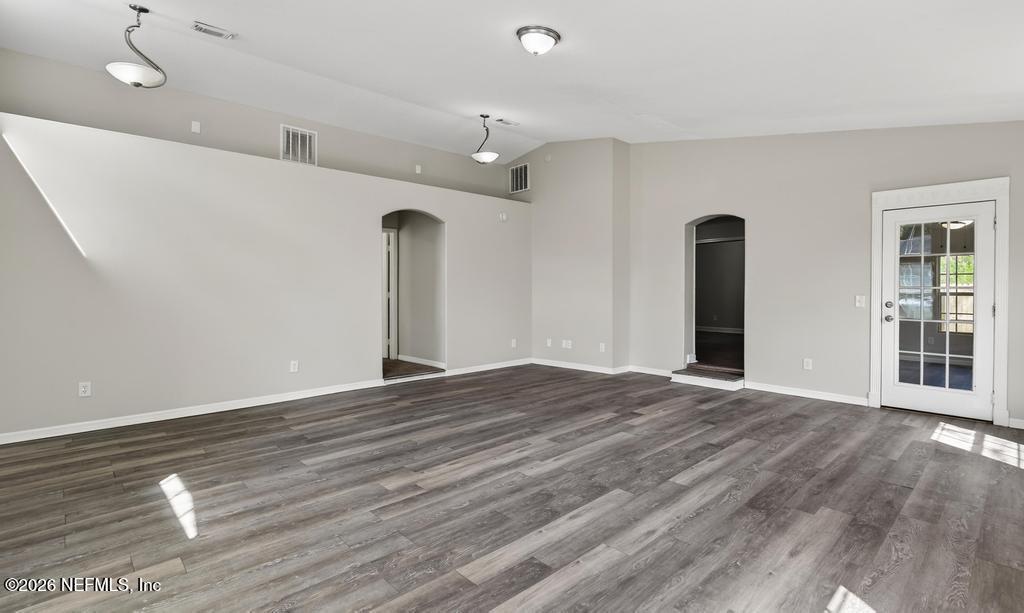 10803 Gladwynne Road Jacksonville, FL 32218 - Photo 8 of 44 a view of an empty room with wooden floor and a window
