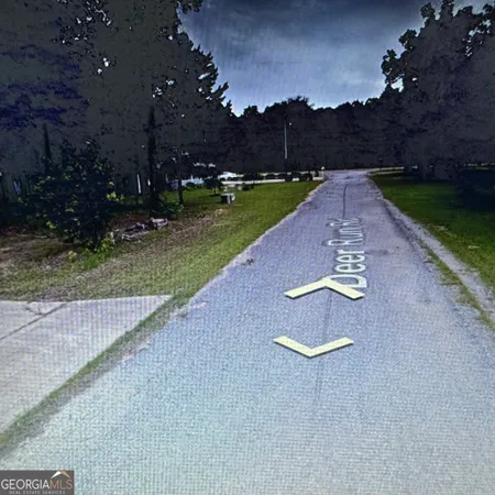 a view of a street with a yard