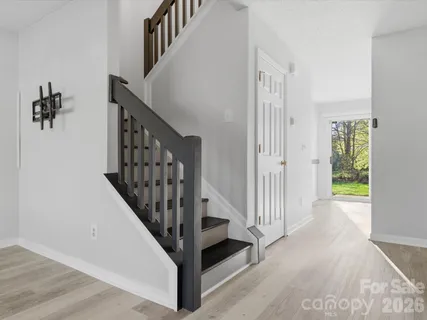 a view of a hallway with wooden floor and entryway