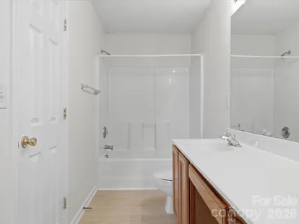 a bathroom with a bathtub sink vanity and a mirror