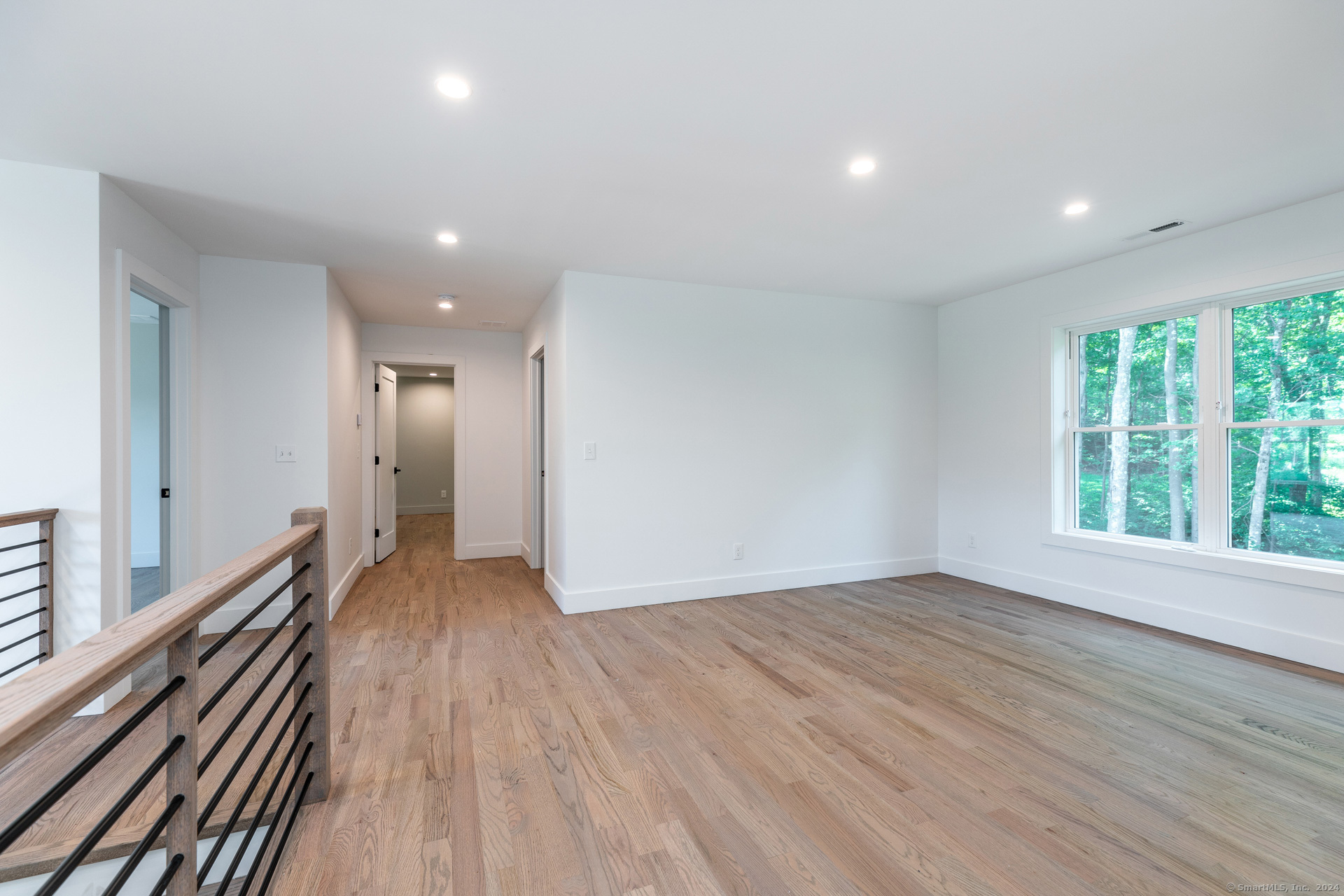 18 Sebastian Trail Newtown, CT 06470 - Photo 15 of 22 an empty room with wooden floor and windows