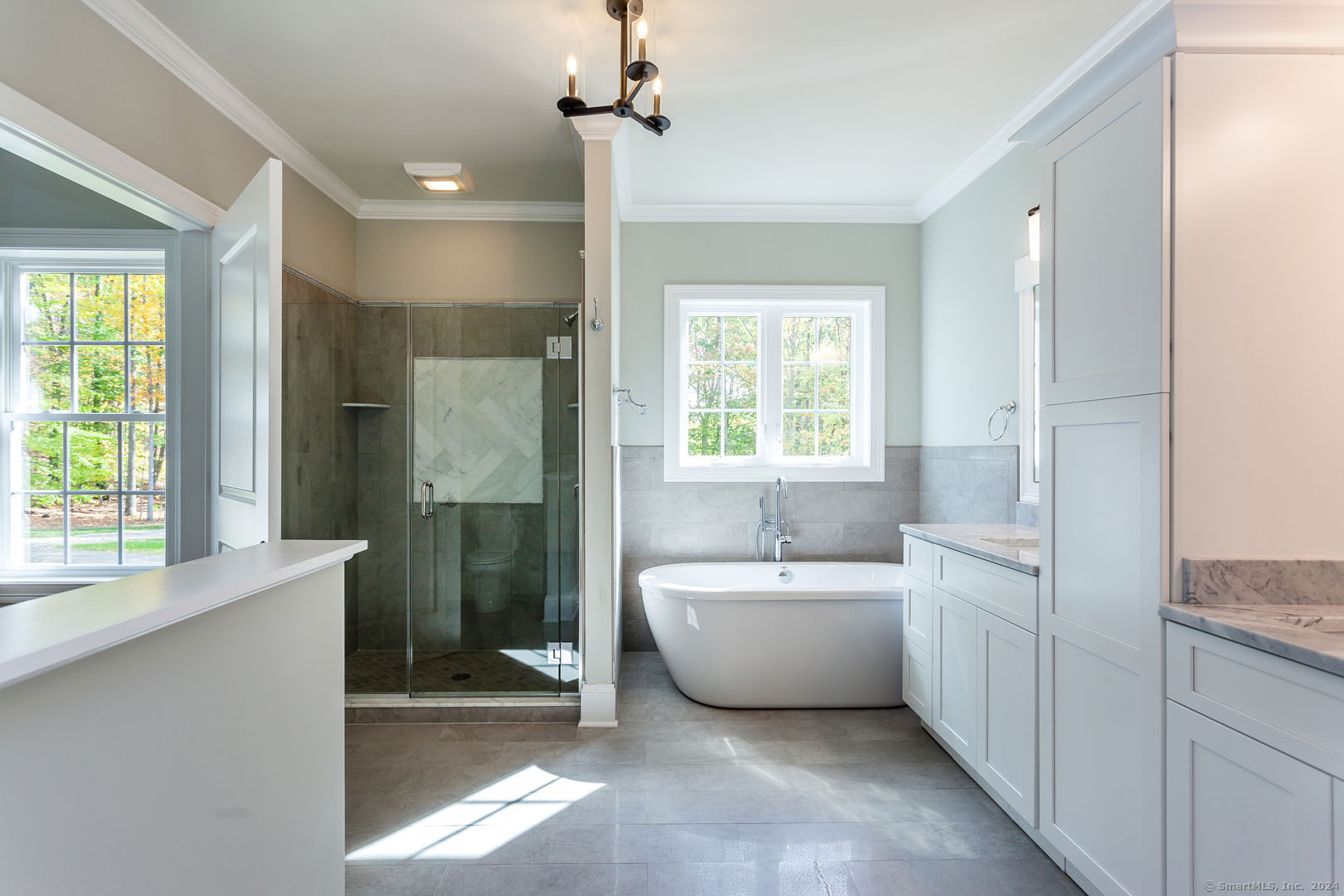 18 Sebastian Trail Newtown, CT 06470 - Photo 20 of 22 a bathroom with a bathtub a sink a window and a shower
