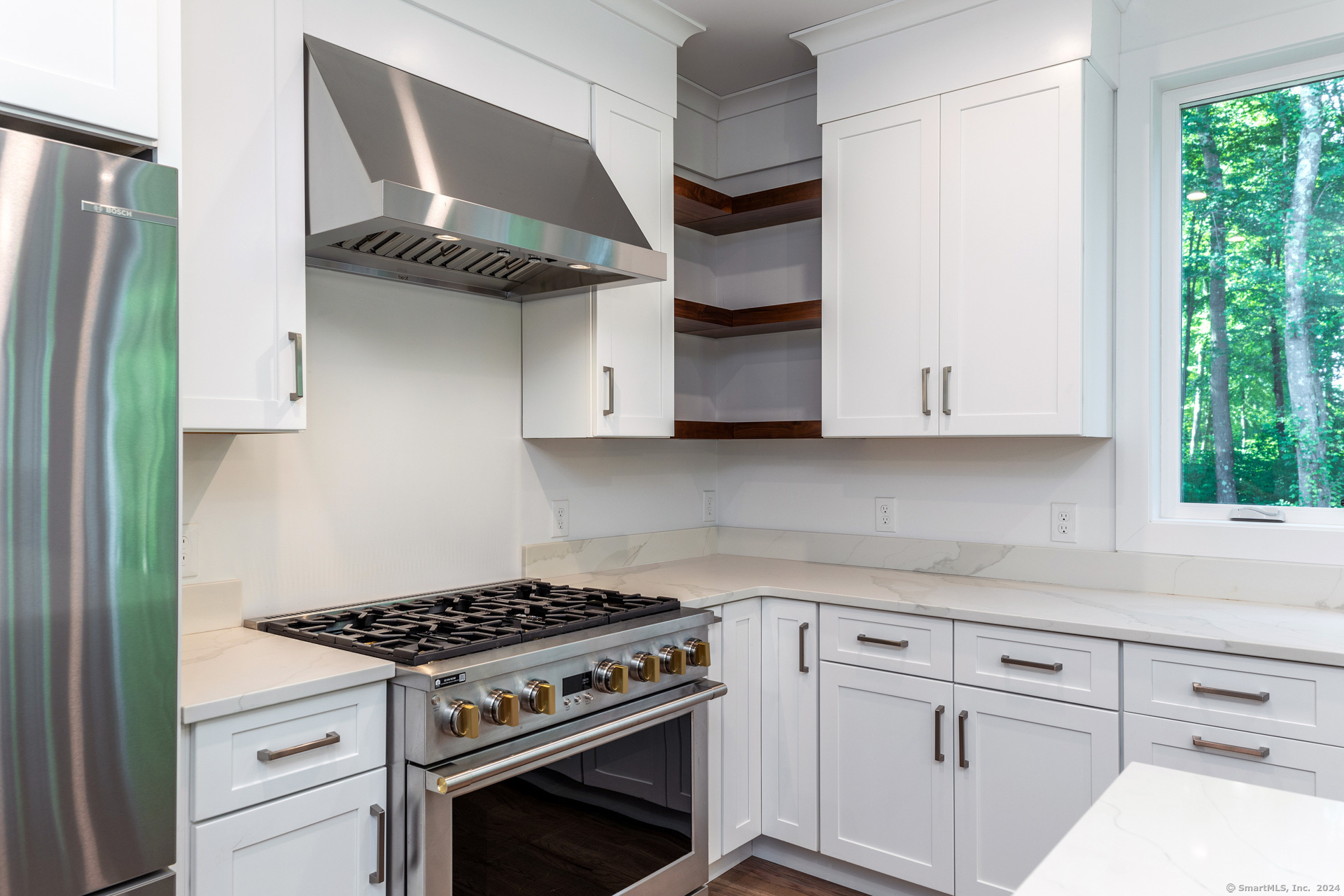 18 Sebastian Trail Newtown, CT 06470 - Photo 5 of 22 a kitchen with stainless steel appliances white cabinets and a stove
