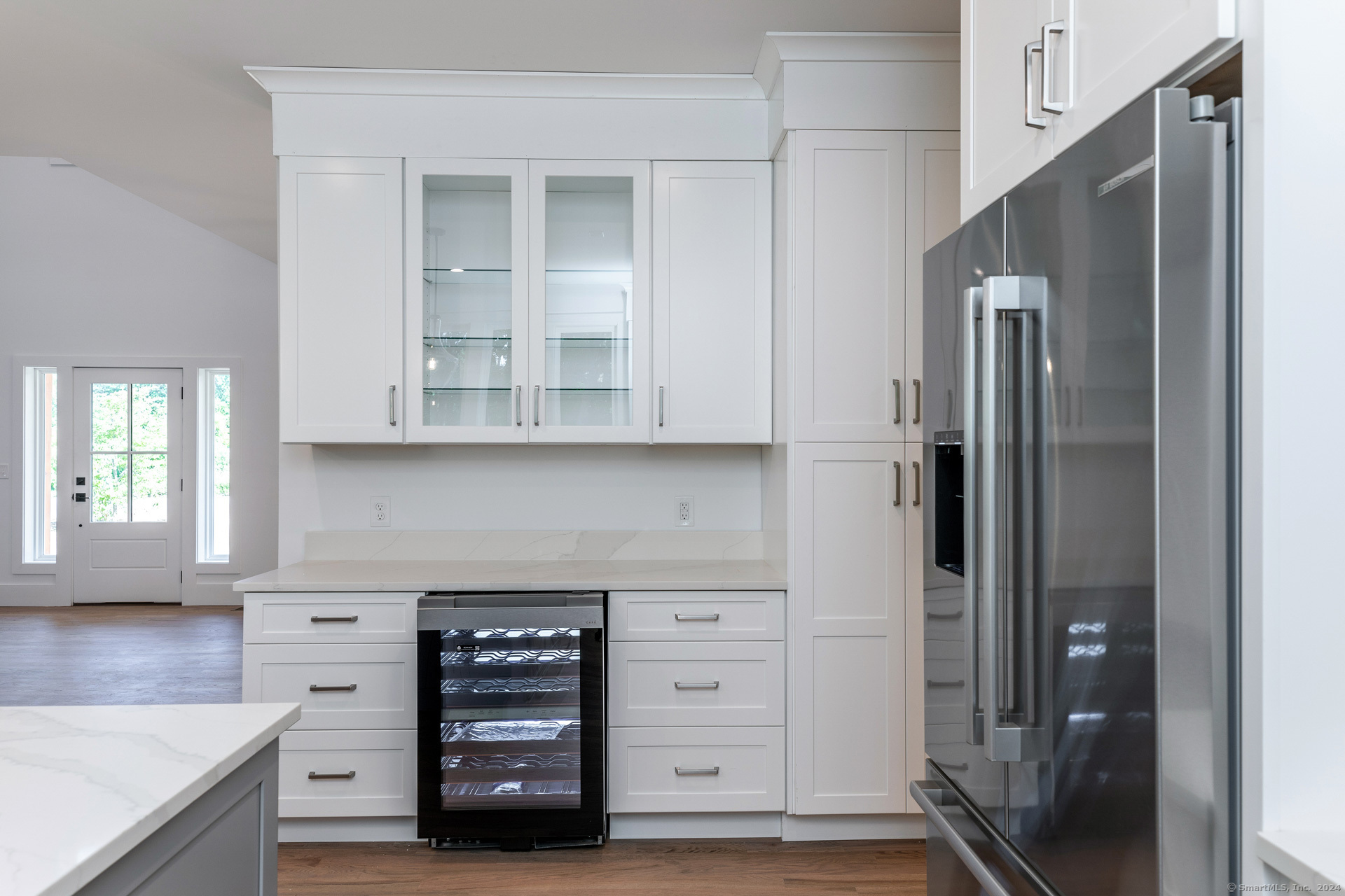18 Sebastian Trail Newtown, CT 06470 - Photo 6 of 22 a kitchen with white cabinets and a refrigerator