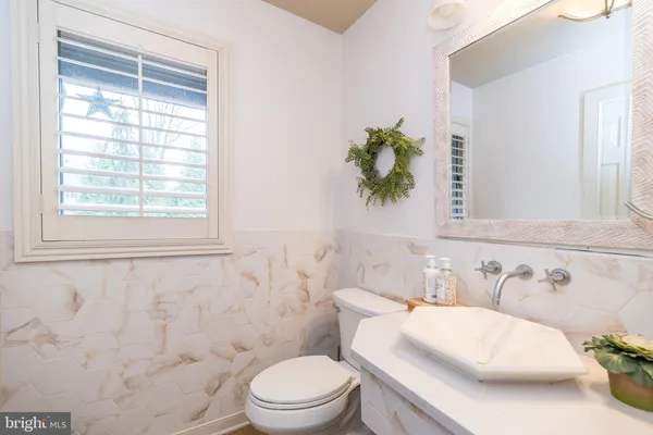 a bathroom with a sink mirror and a bathtub