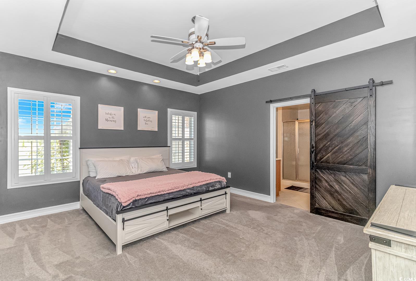 3286 State Rd S-26-777 Loris, SC 29569 - Photo 14 of 40 Carpeted bedroom featuring a barn door, ensuite ba