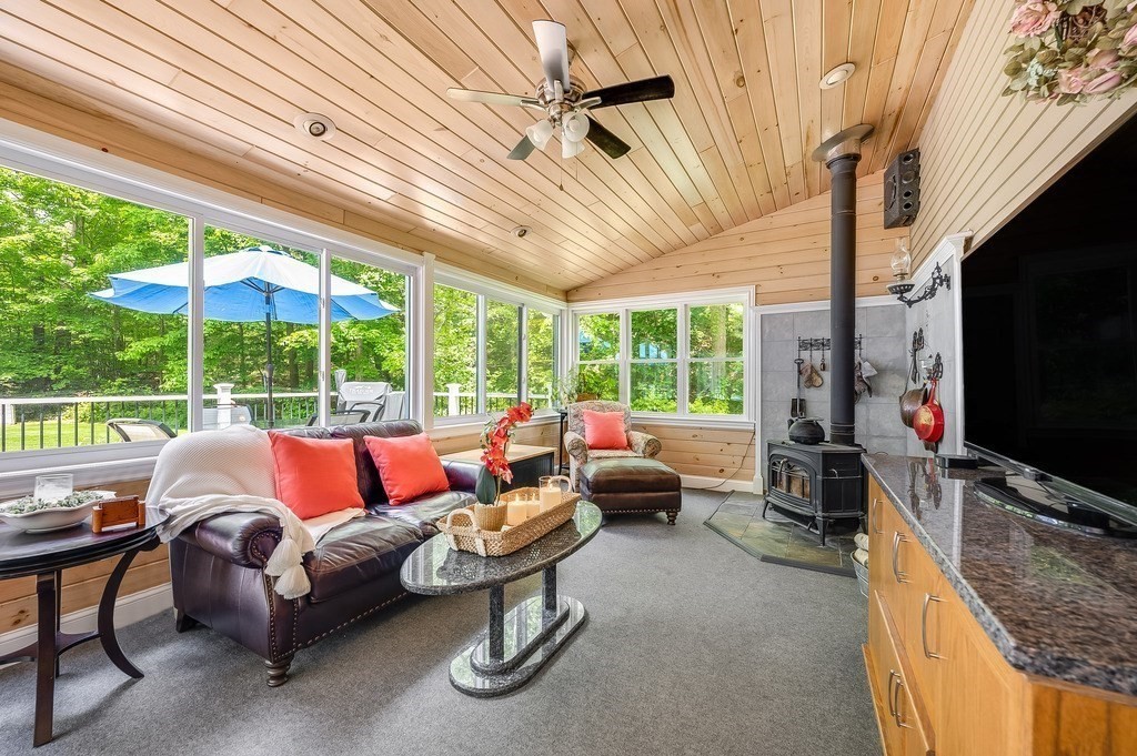a outdoor living space with furniture tv and a window