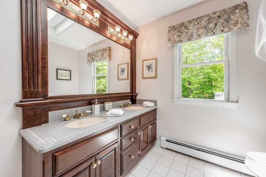 2470 West Street Wrentham, MA 02093 - Photo 25 of 42 a bathroom with a sink and a mirror