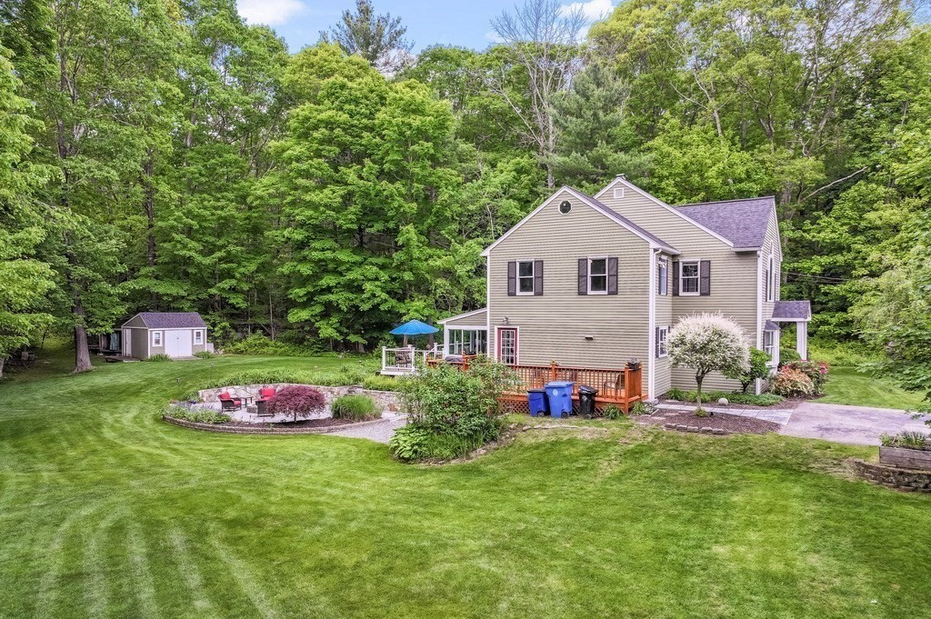 2470 West Street Wrentham, MA 02093 - Photo 41 of 42 a front view of a house with a big yard and potted plants