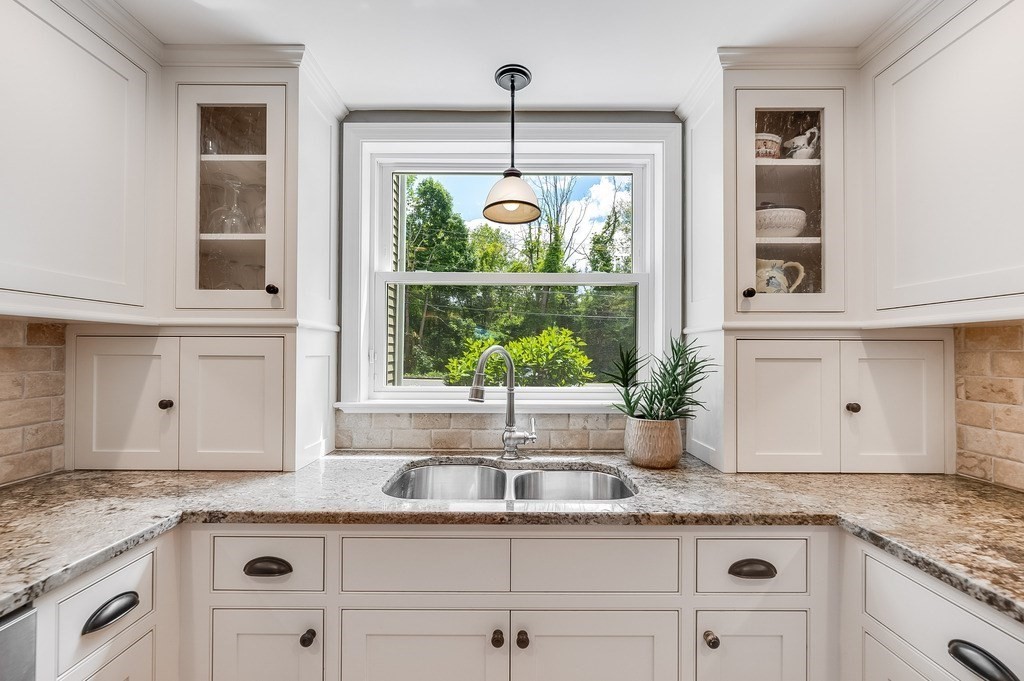2470 West Street Wrentham, MA 02093 - Photo 6 of 42 a kitchen with stainless steel appliances granite countertop a sink a stove and cabinets