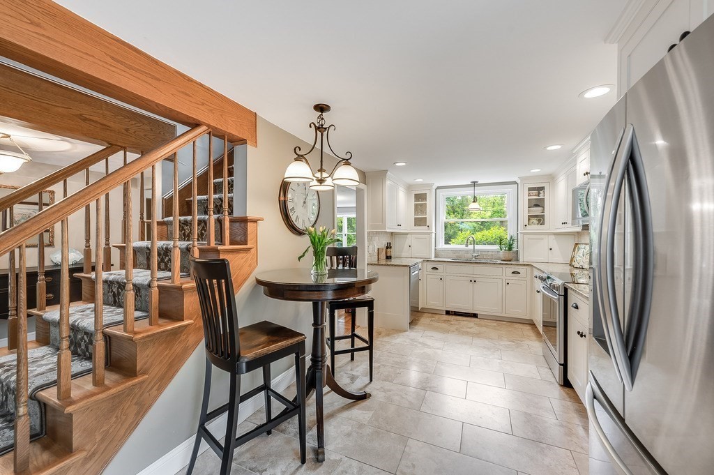 2470 West Street Wrentham, MA 02093 - Photo 10 of 42 a kitchen with stainless steel appliances kitchen island granite countertop furniture and a refrigerator