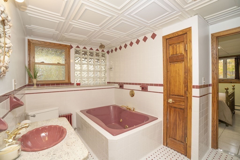 54 Gorham Street Rehoboth, MA 02769 - Photo 25 of 40 a bathroom with a sink a bathtub and a window