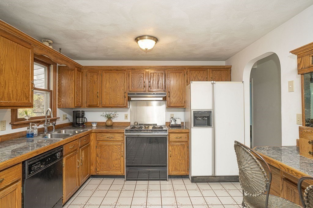 54 Gorham Street Rehoboth, MA 02769 - Photo 6 of 40 a kitchen with a sink a stove and refrigerator