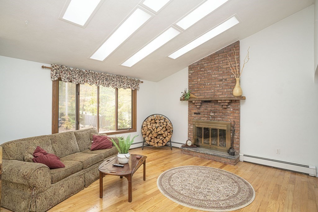 54 Gorham Street Rehoboth, MA 02769 - Photo 10 of 40 a living room with furniture fireplace and a table