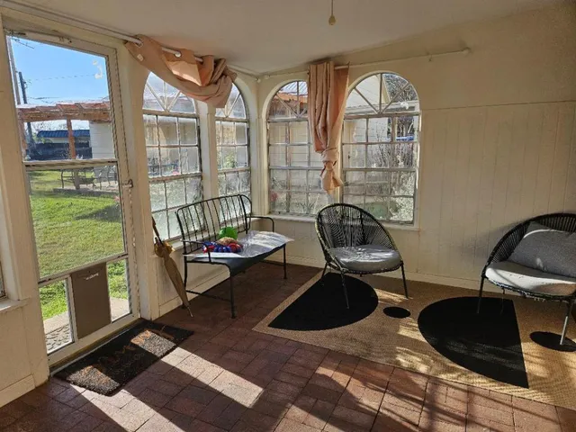 a living room with furniture and a floor to ceiling window