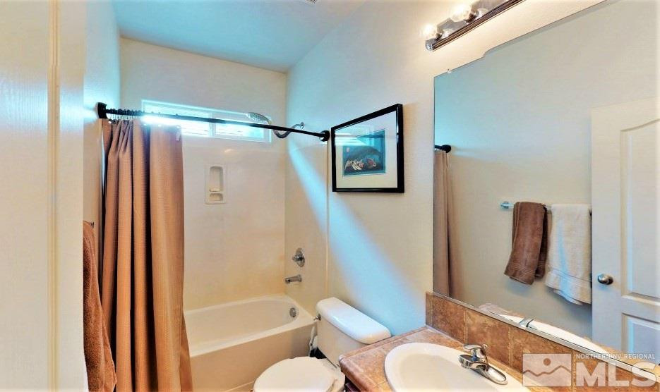 11200 Messina Way Reno, NV 89521 - Photo 16 of 19 a bathroom with a shower a toilet and a sink