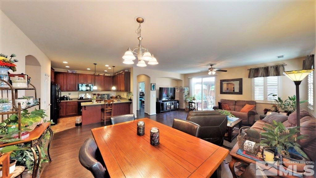 11200 Messina Way Reno, NV 89521 - Photo 3 of 19 a view of a dining room and livingroom with furniture wooden floor a rug a potted plant and a chandelier