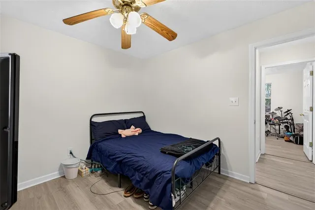 a bedroom with a bed and wooden floor
