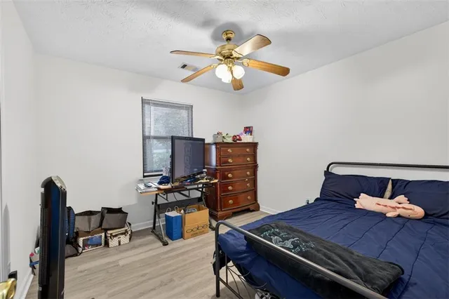 a bedroom with furniture and wooden floor